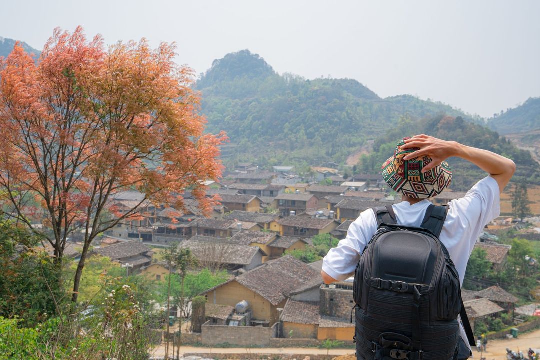 A traveller looking out over a hillside village