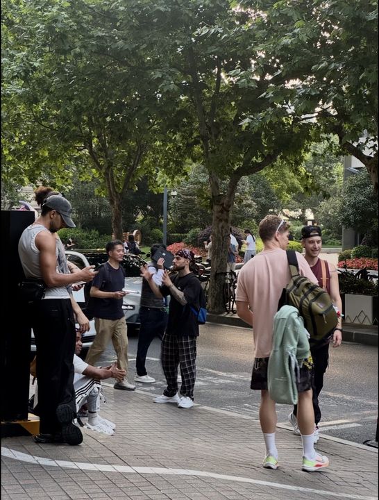 Travellers on a tree-lined city street