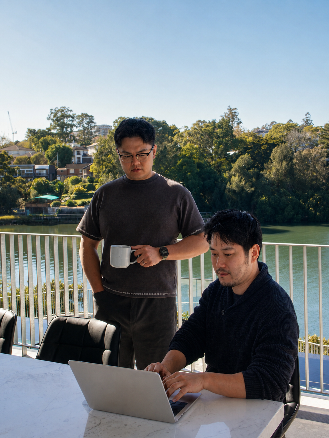 Frank and Leo planning a JadeDays journey together on a Sydney waterside balcony