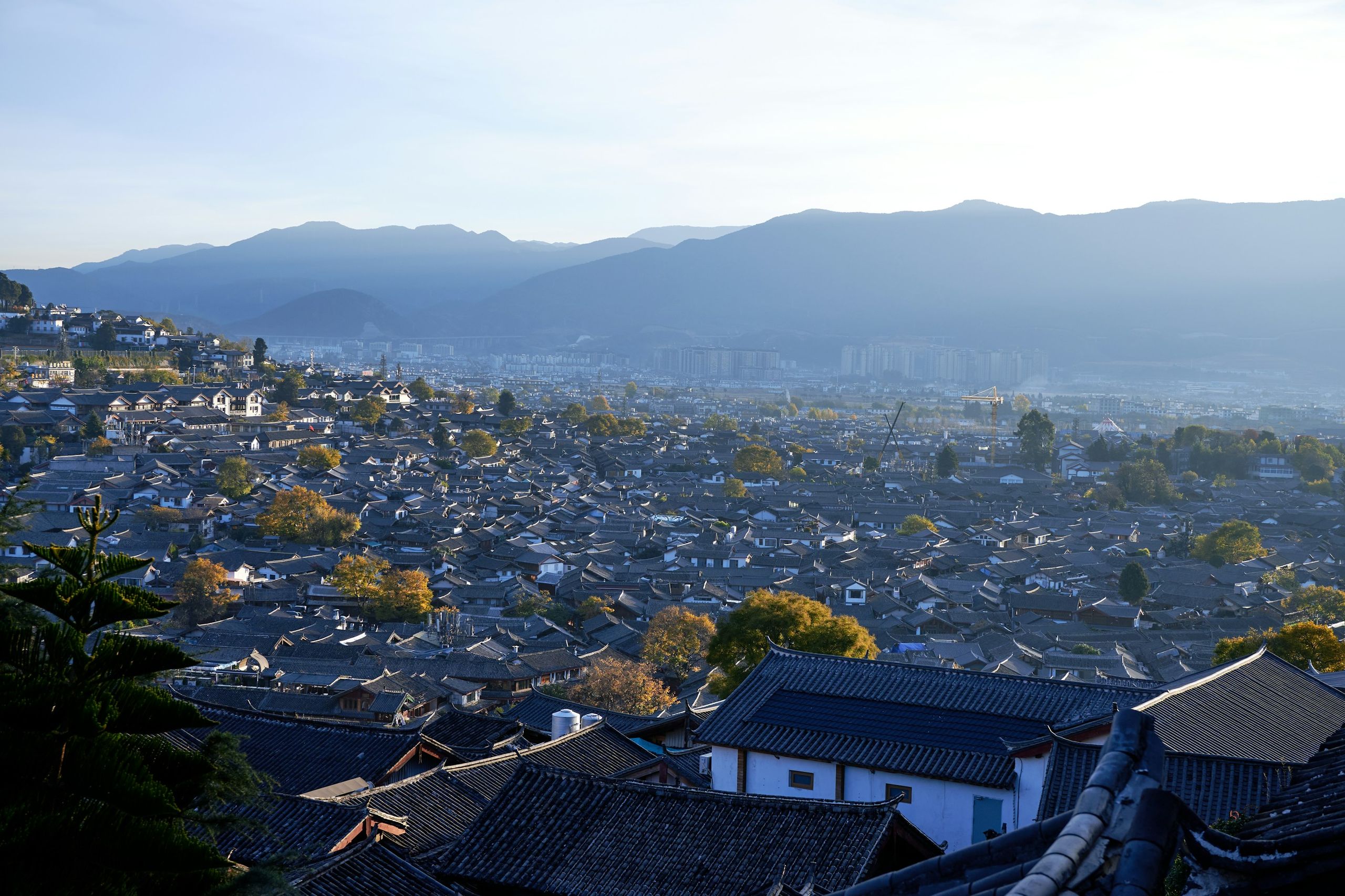Lijiang rooftops and mountains in Yunnan